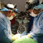 Surgical team performing an operation in a hospital operating theatre
