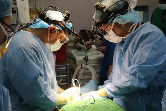 Surgical team performing an operation in a hospital operating theatre