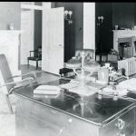 Journalists working at screens in a modern newsroom