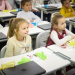 Students learning in a phone-free classroom, focused on their lesson